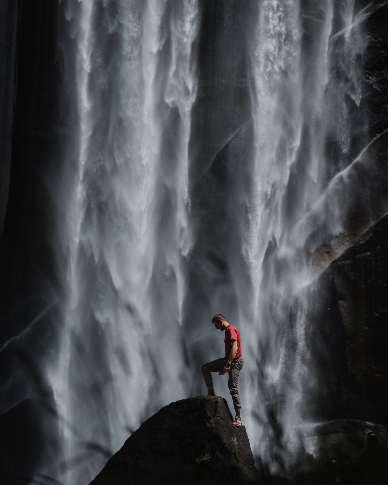 person-in-red-shirt-stepping-on-rock-3421382