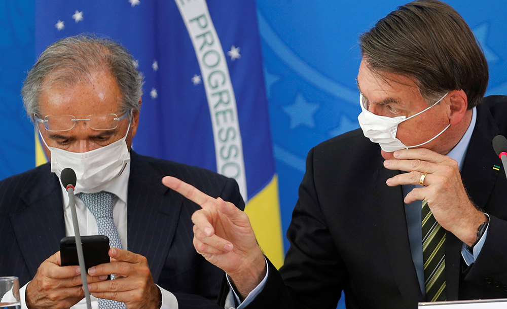 Brazil’s President Jair Bolsonaro and Brazil’s Economy Minister Paulo Guedes, wearing protective face masks, hold a news conference to announce measures to curb the spread of the coronavirus disease (COVID-19) in Brasilia